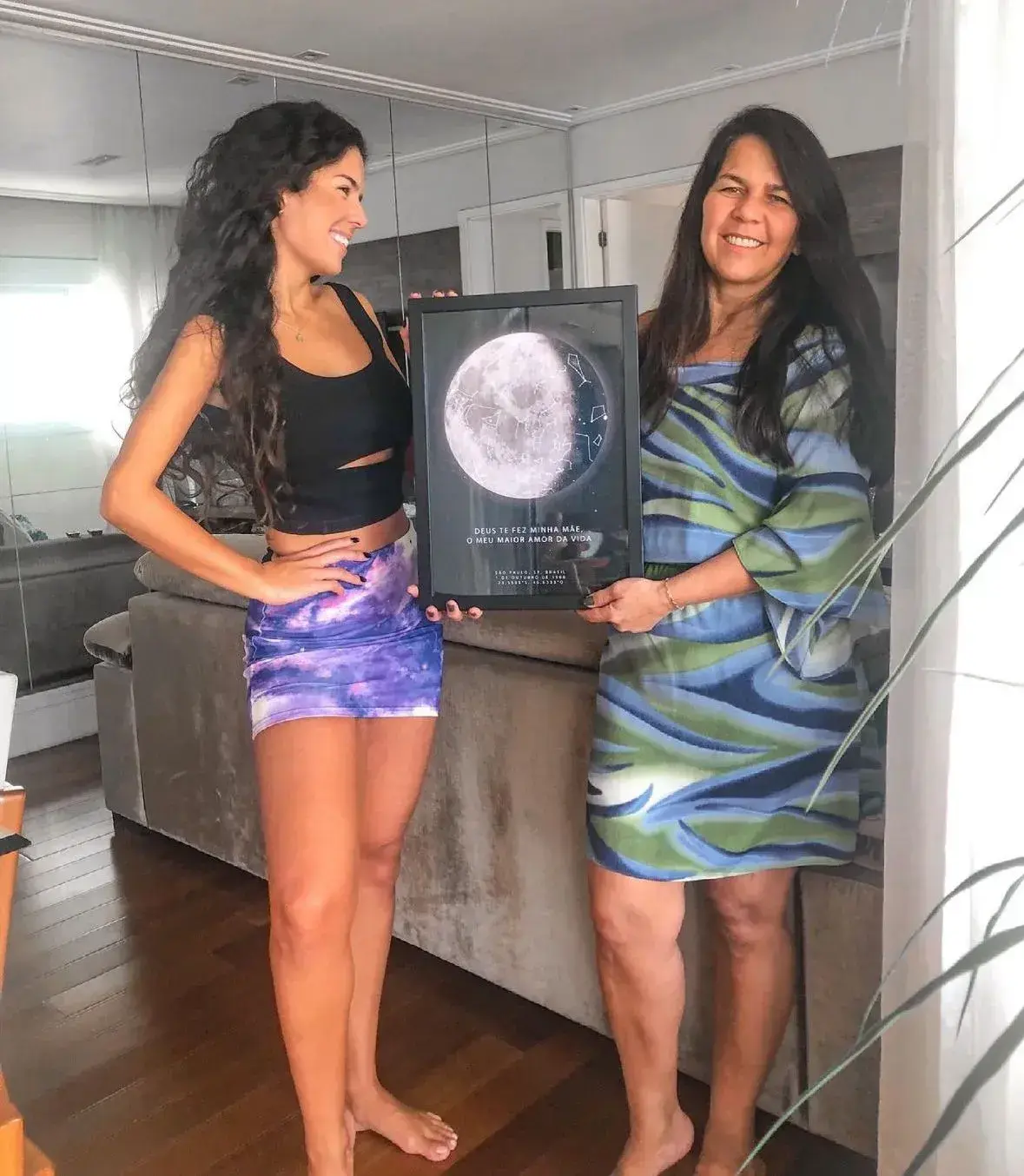 Mother emotional with framed star map, gift from daughterRetry